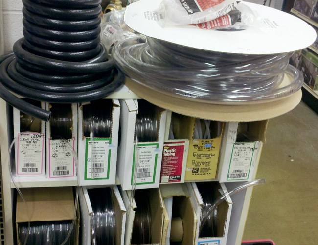 Spools of vinyl and poly tubing and wire on a store rack