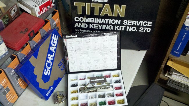 Schlage and Titan keying kit open on the counter for re-keying locks